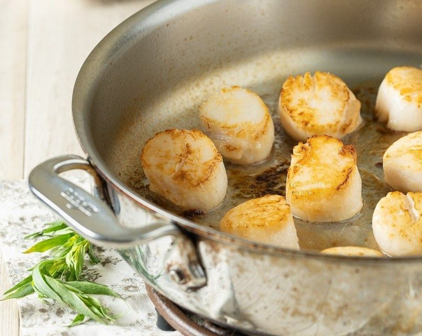 step 2 Heat Canola Oil (1 Tbsp) in a large skillet over medium-high heat. When the oil is hot add scallops and cook for approximately 2 minutes per side depending on size. Flip scallops and cook for an additional 2 minutes.
