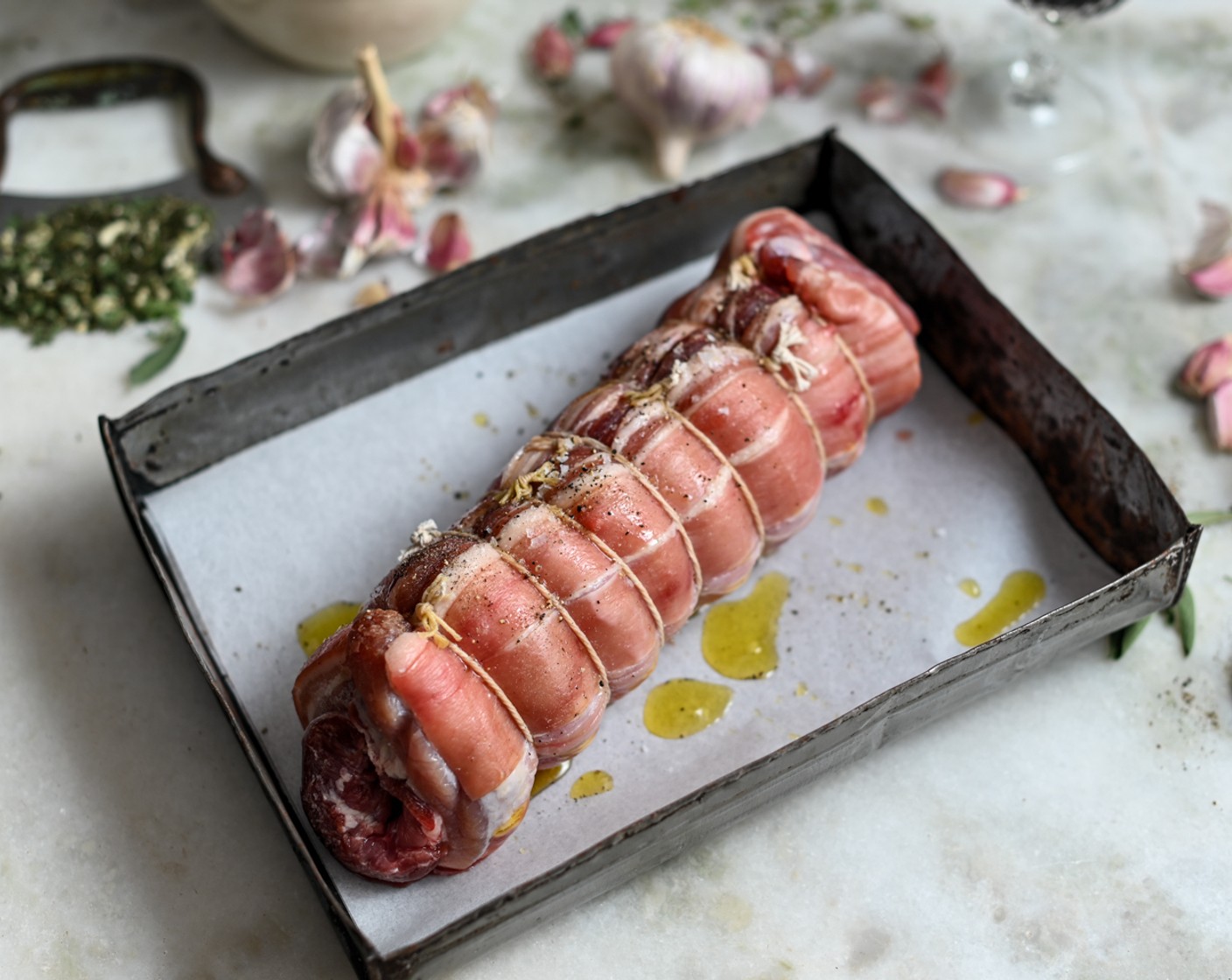 step 4 Cut 10 lengths of string/kitchen twine, each about 30 cm long. Sprinkle the herbs, Fennel Seeds (2 1/2 Tbsp) and garlic, over the pork. Carefully roll up from one of the long ends, then tie very tightly with string in the middle of the roll.