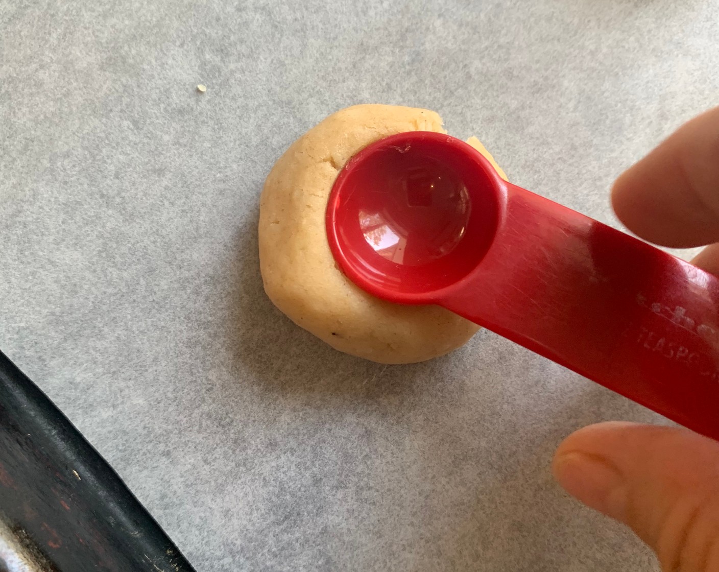 step 8 Remove the dough from the refrigerator and form balls (about 1 ½ to 2 inches) and either using your thumb or the back of a small measuring spoon make an indentation for the tomato jam.