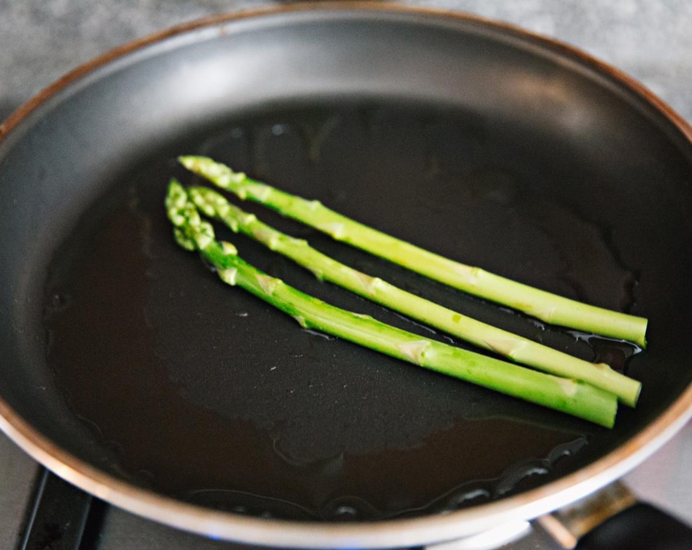 step 7 Add olive oil to the pan and fry the Asparagus (3 stalks) lightly until they turn slightly more green.