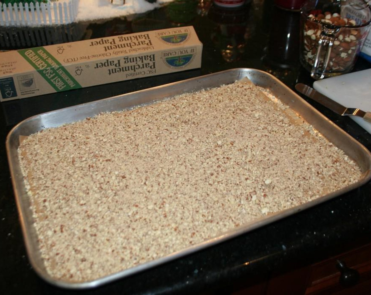 step 2 Line a baking sheet pan with parchment paper - set aside. In a food processor grind the remaining almonds into a coarse meal. Place almond meal on the baking sheet with the parchment paper.