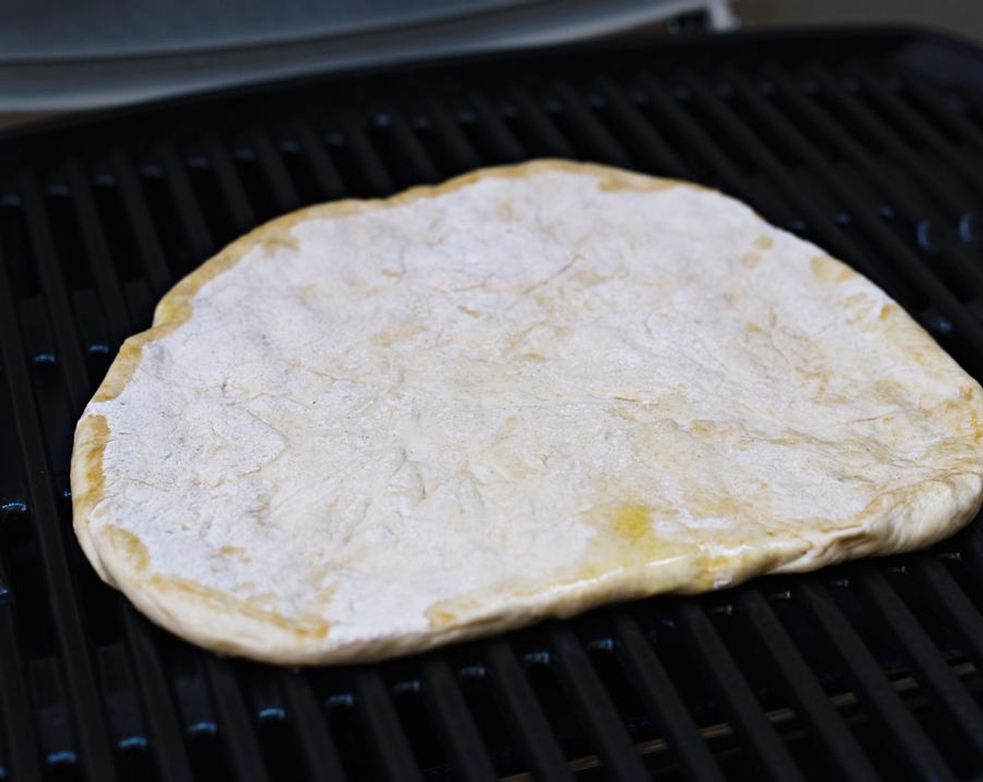 step 4 Place dough onto grill, oiled side down. Grill for 5 minutes on medium heat.