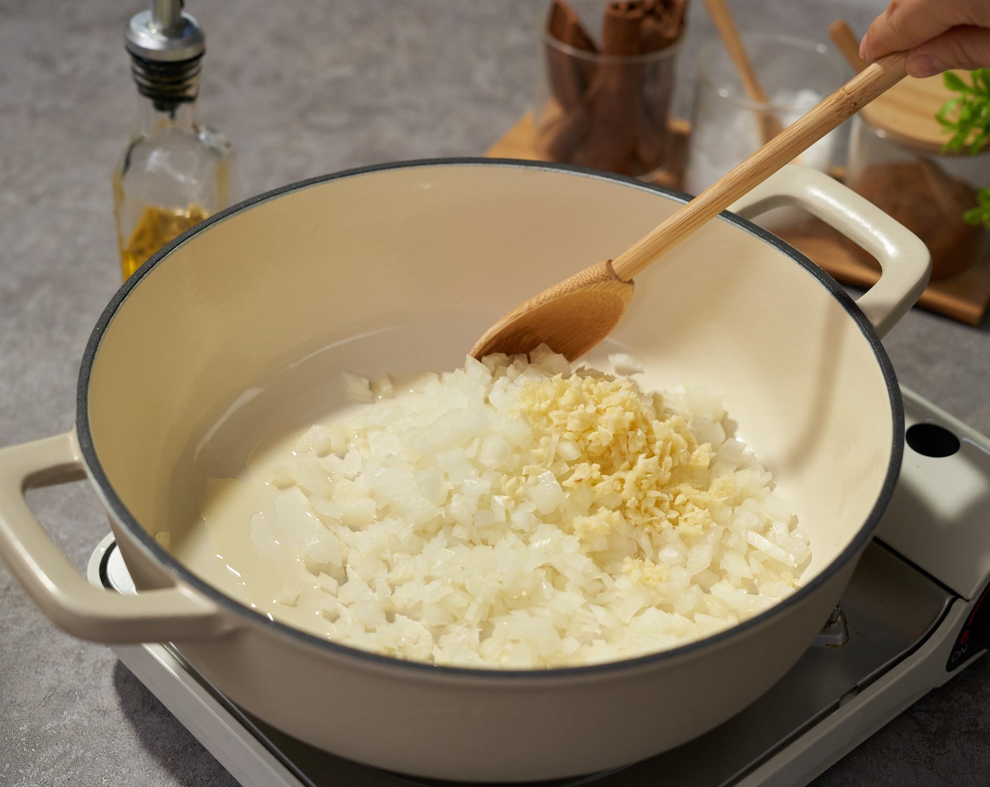 step 1 Place the dutch oven on medium-high heat, and add Vegetable Oil (2 Tbsp). Once it is hot, add Yellow Onion (1) and Garlic (6 cloves). Cook for 4-5 minutes or until the onion is translucent.