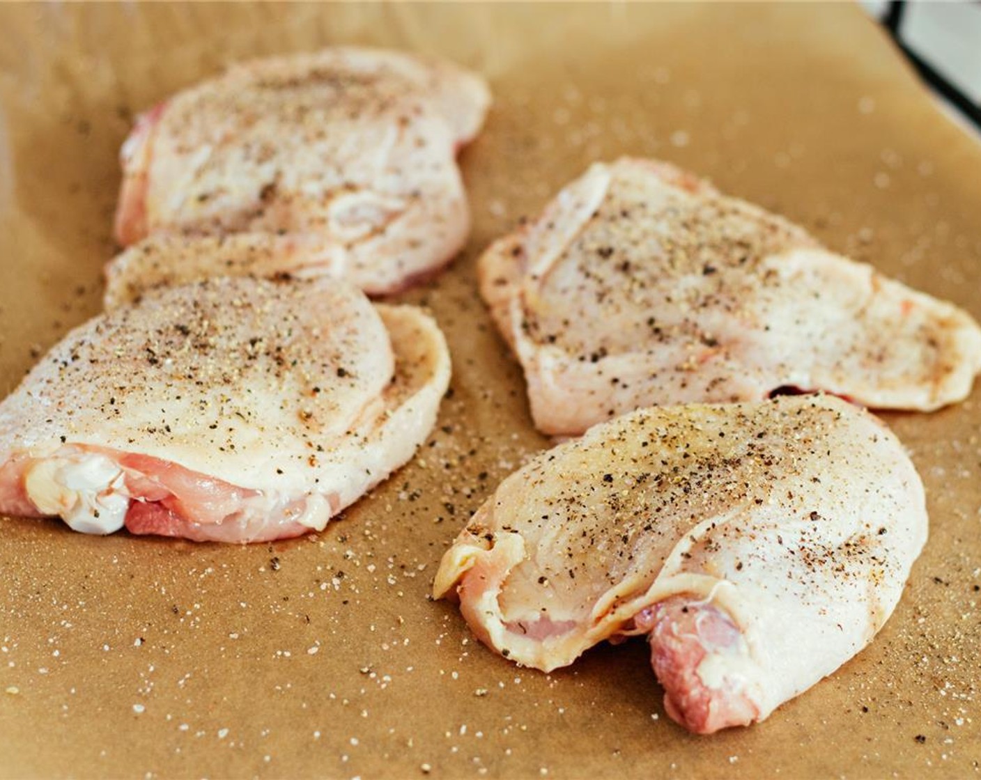 step 4 While the potatoes cook, season Bone-In Chicken Thighs (4) all over with Salt (to taste) and Ground Black Pepper (to taste). Heat a large cast-iron skillet over medium heat with the other Coconut Oil (1 tsp).