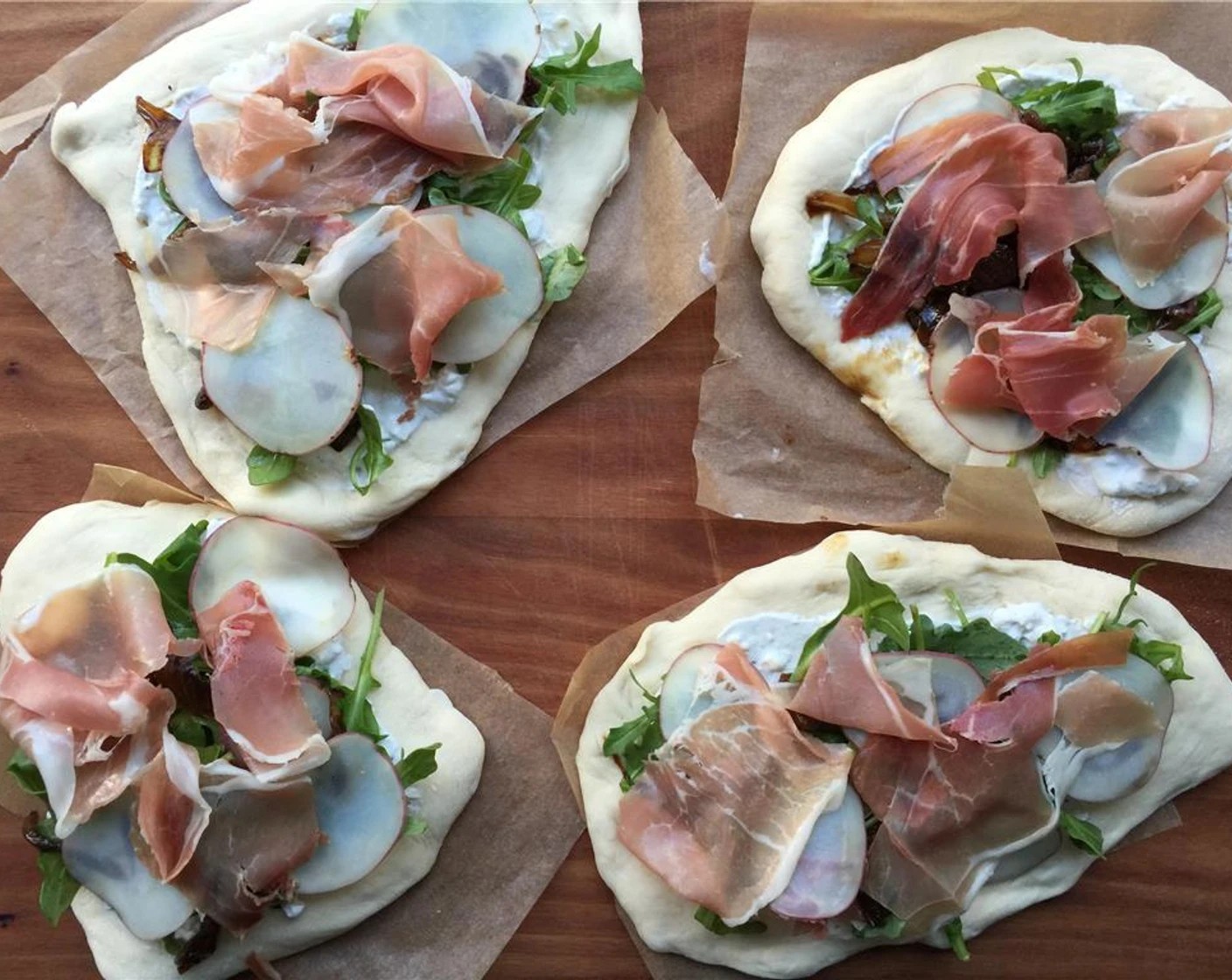 step 12 Next add the Arugula (1 cup), glazed onions, potatoes, and pieces of Prosciutto (4 oz). Bake the flatbreads in your oven until golden, 6-10 minutes. You can either directly place them on the oven rack or use a baking pan.