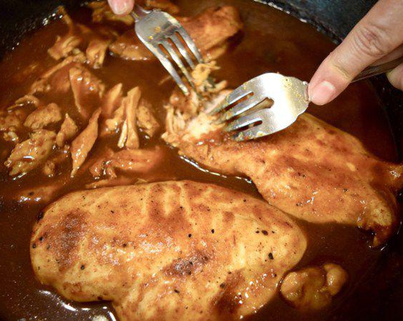 step 8 Using two forks, pull the chicken apart. Allow the chicken to sit in the the sauce and soak up some of the goodness for around 5-10 minutes. Then, its time to toast up some buns if your going the sandwich route, or just enjoy it as is.