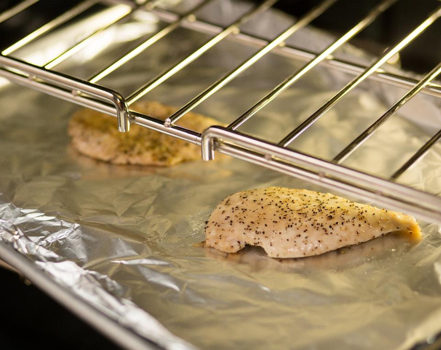 step 8 Place the chicken on a sheet pan lined with foil and bake for 8 minutes. Remove the chicken from the pan, cut into 1/2 inch diced pieces; set aside.