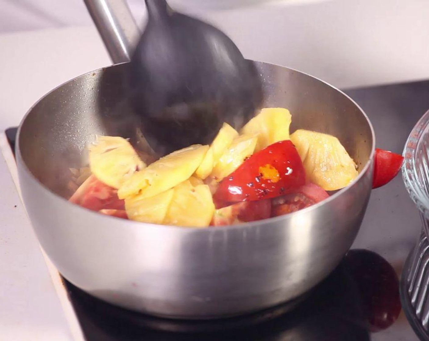 step 5 Sauté Garlic (2 cloves), Cooking Oil (2 Tbsp), add Chili Powder (1 tsp), tomato and pineapple, then pour into the soup.