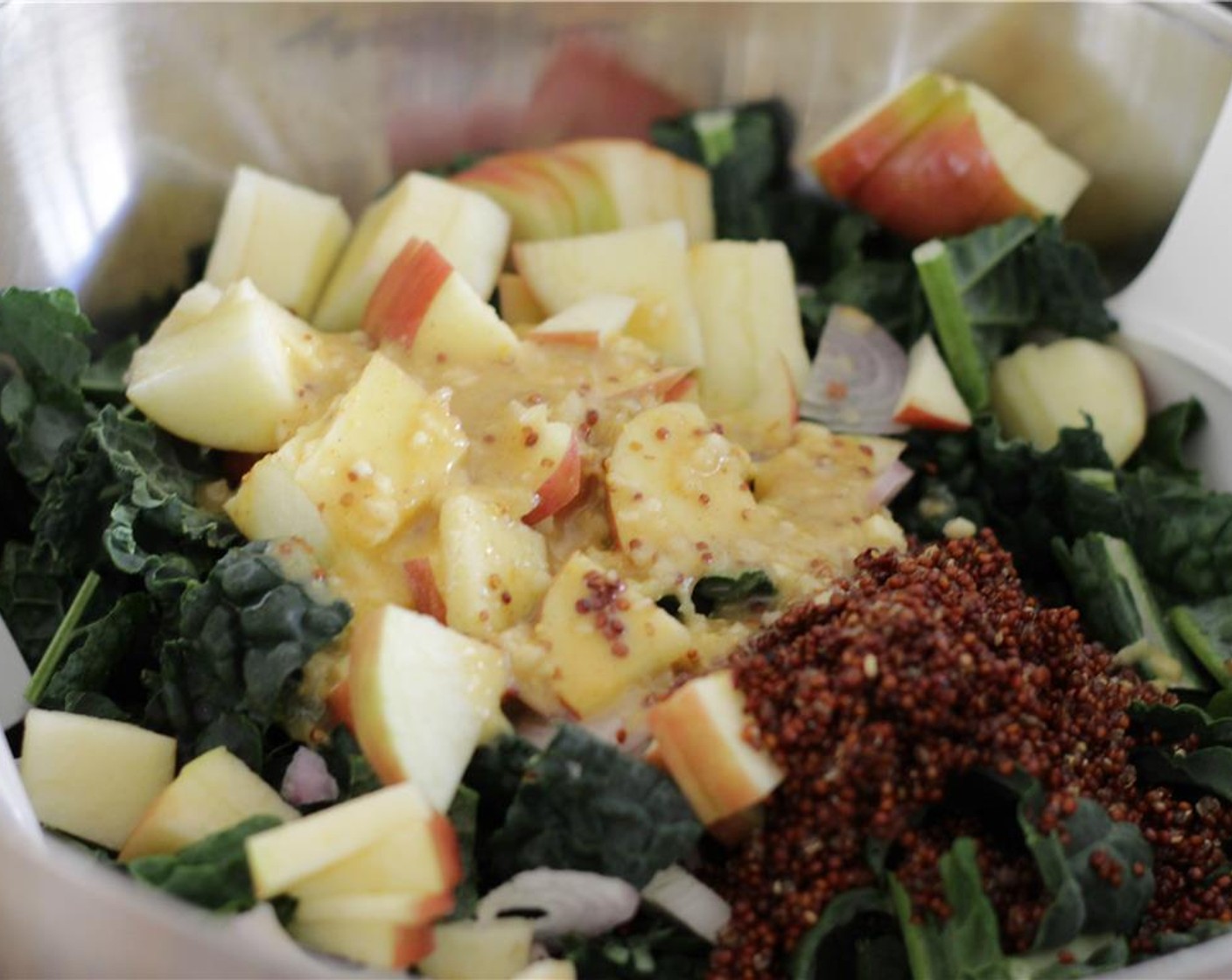 step 12 Add the marinated shallot, cooked quinoa, and salad dressing to the bowl. Toss thoroughly to infuse the dressing into the kale. Let sit for 10 minutes to marinate.