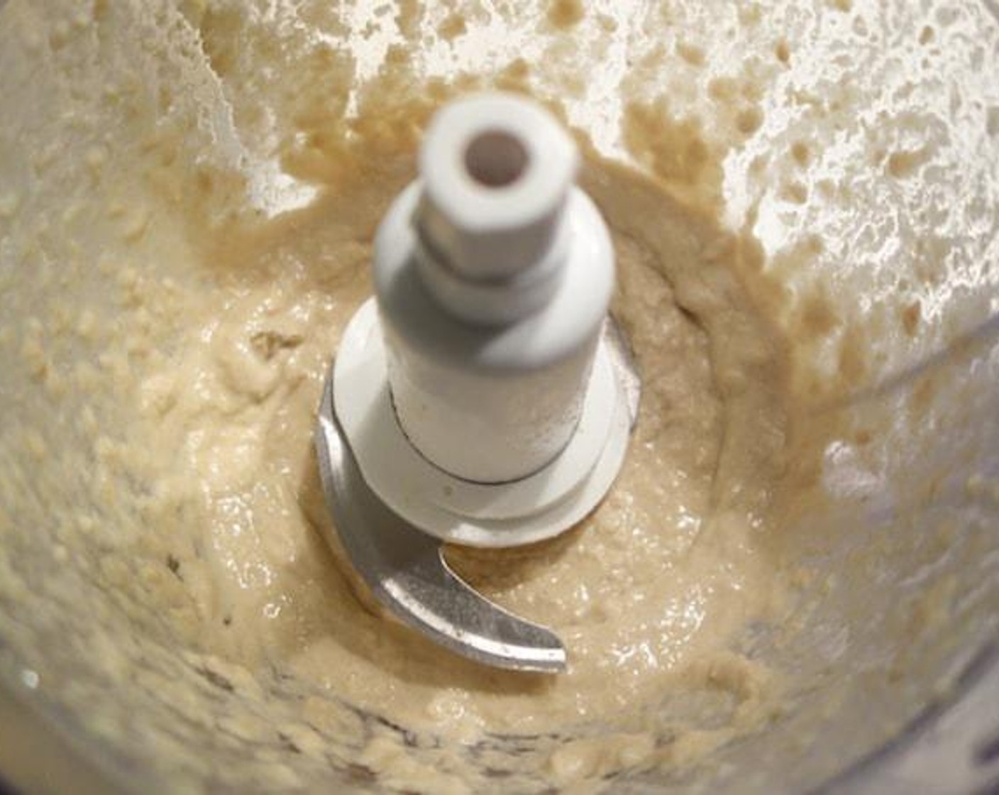 step 4 Cut Garlic (2 cloves) then add the Tahini (1/3 cup) and the juice from Lemons (2 1/2) in a food processor. Blend for 10 seconds.