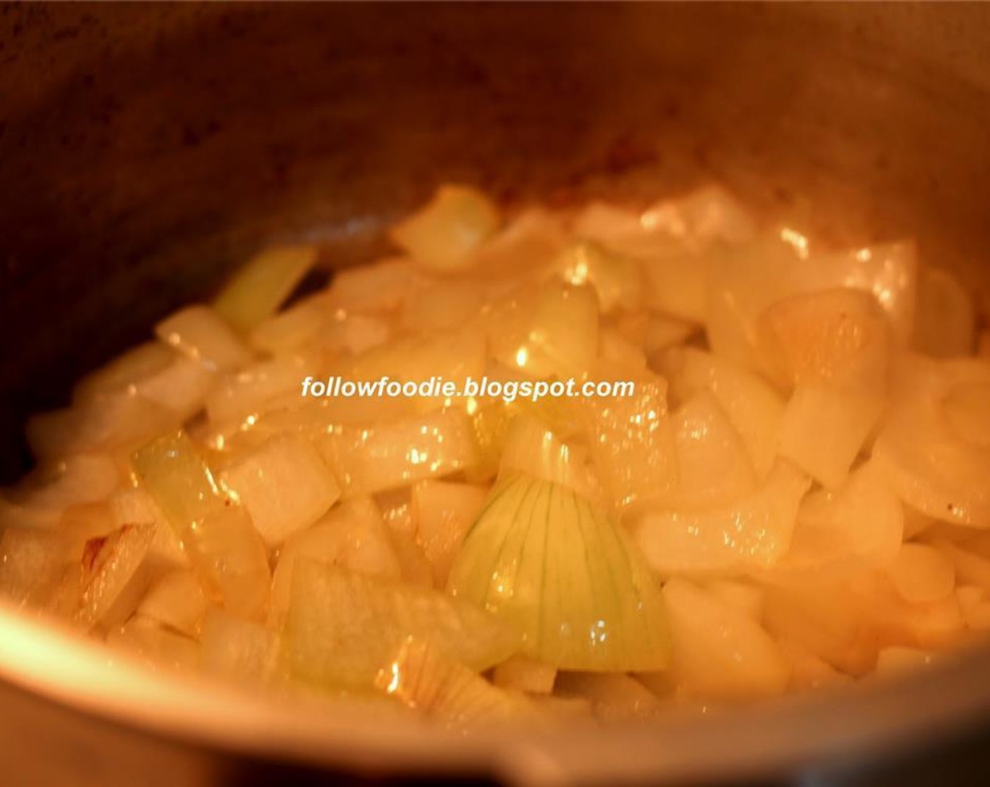 step 7 In the pressure cooker, heat some more Oil (2 Tbsp) and cook the chopped onions until translucent.