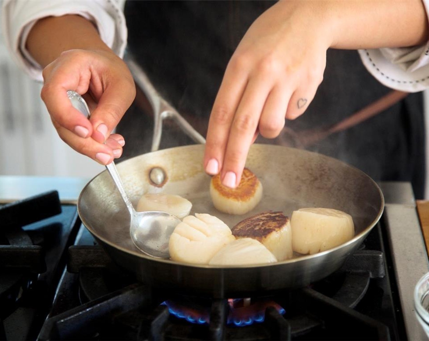 step 16 Add remaining butter and turn scallops over. Cook only one minute on the second side. Using a spoon, baste scallops with butter. Remove from heat and hold until plating.