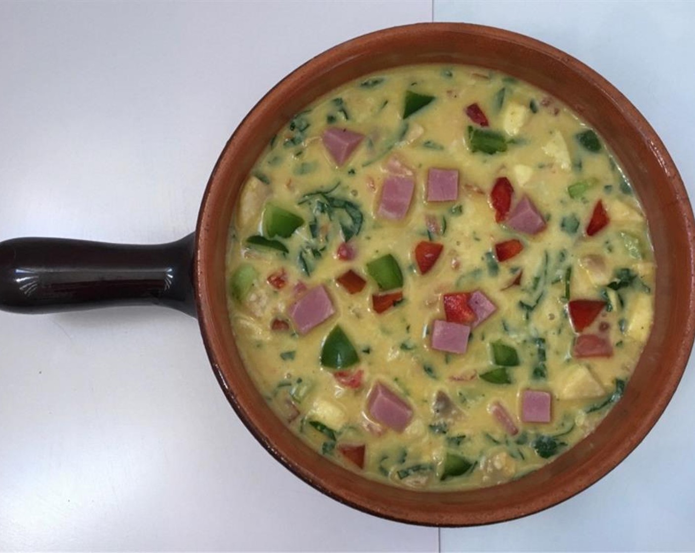 step 8 Grease a small baking dish with the Unsalted Butter (1 Tbsp). Then pour the large egg and vegetable mixture in it. Place the dish in a preheated oven at 400 degrees F (200 degrees C) for about 20 to 25 minutes (depends on the thickness of the casserole).