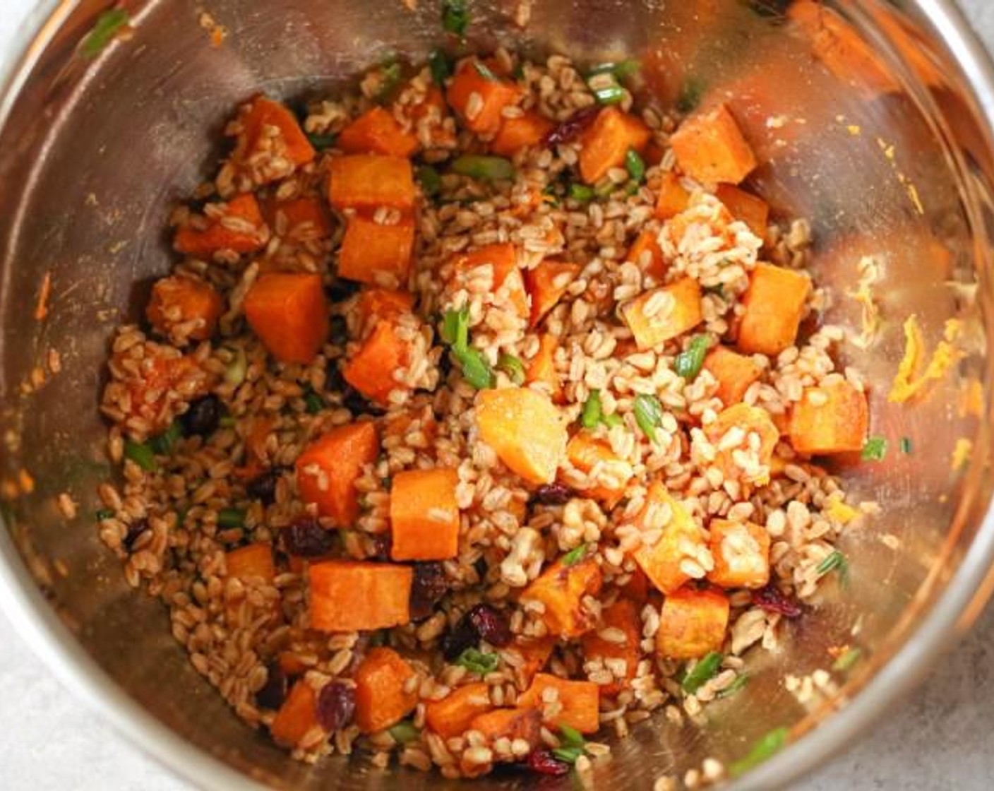 step 7 Add the cooked farro to the bowl with the dressing and toss to combine. Add the roasted butternut squash, Walnut (1/2 cup), Dried Cranberries (1/3 cup), and Scallion (1 bunch) and fold all the ingredients together. Taste and season with freshly Freshly Ground Black Pepper (to taste) and a little extra salt (if needed).