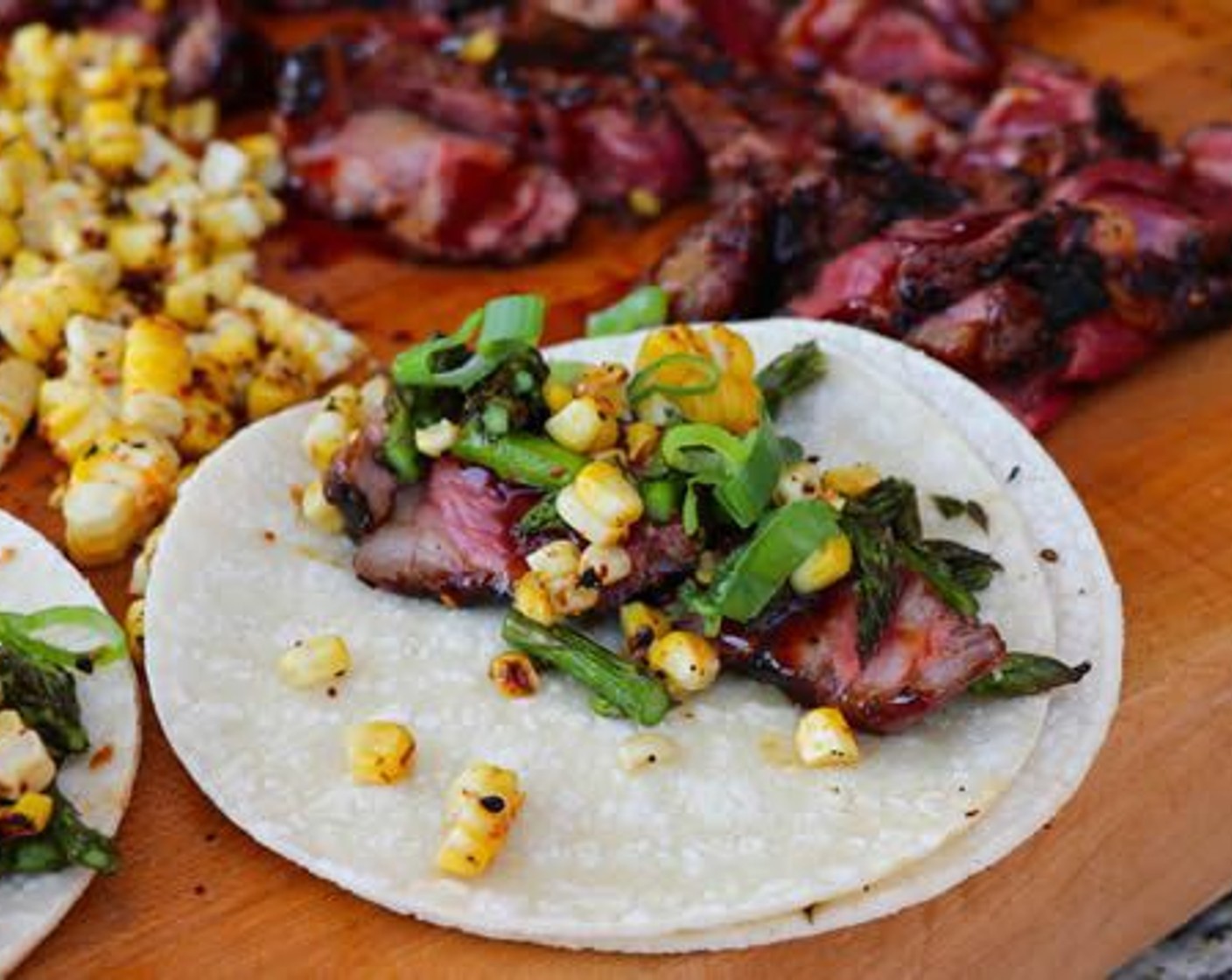 step 14 Serve ribeye slices, chopped asparagus and corn with tacos. Enjoy!