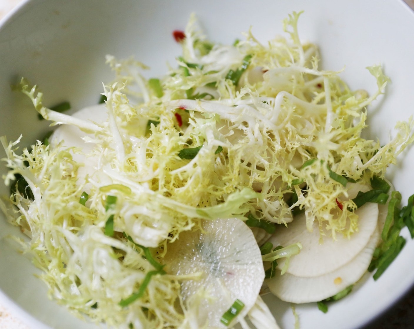 step 13 Toss the Curly Endive (2 cups), Daikon Radish (1 cup), and the green part of the Scallion (1/3 cup) with the dressing.