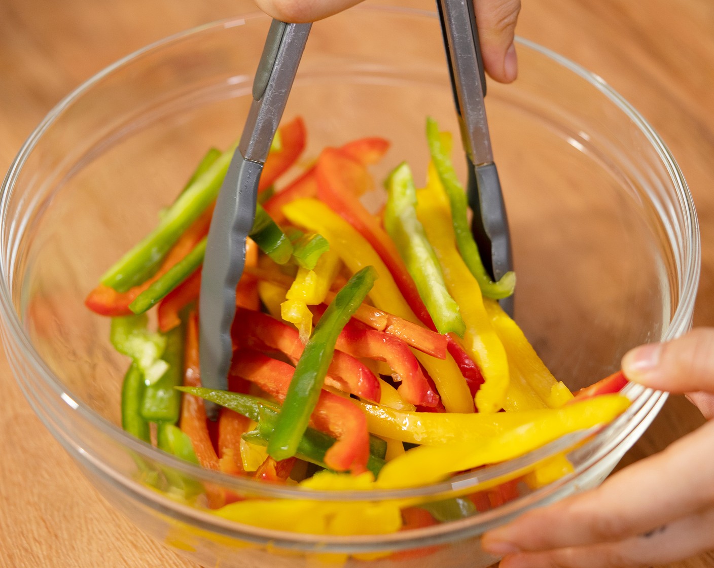 step 3 Toss the Red Bell Pepper (1), Yellow Bell Pepper (1), and Green Bell Pepper (1) with Oil (1/2 Tbsp) in a mixing bowl.