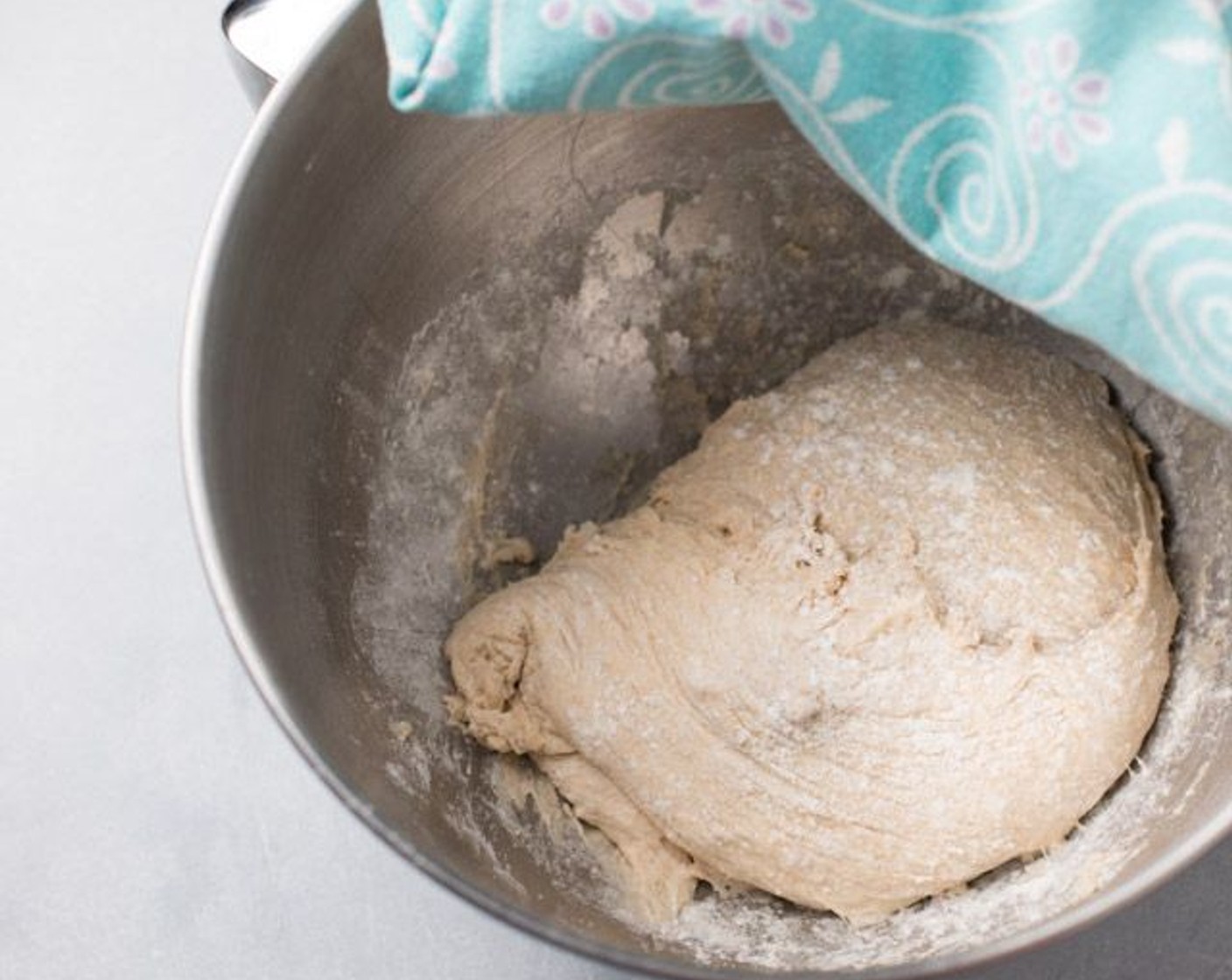 step 4 When done mixing, lightly flour your dough on the top and all sides (using a spatula to flip dough) to prevent excessive sticking. Cover the bowl with a towel and let rise for 1 hour.