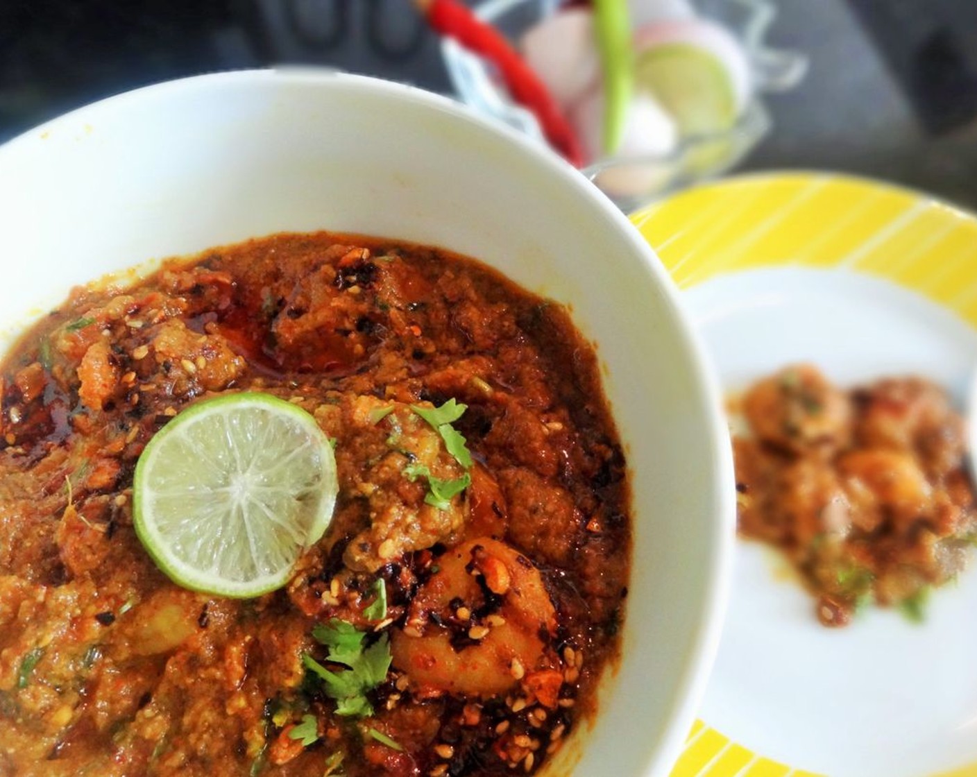 step 5 In a small pan or a tadka pan, add oil and let it heat. Add chopped Garlic (7 cloves), crushed chili, Poppy Seeds (1/2 tsp) and curry masala. Fry it until aroma came. Then pour it over the prawn masala curry. Garnish with coriander leaves, sliced onion and lemon wedges.