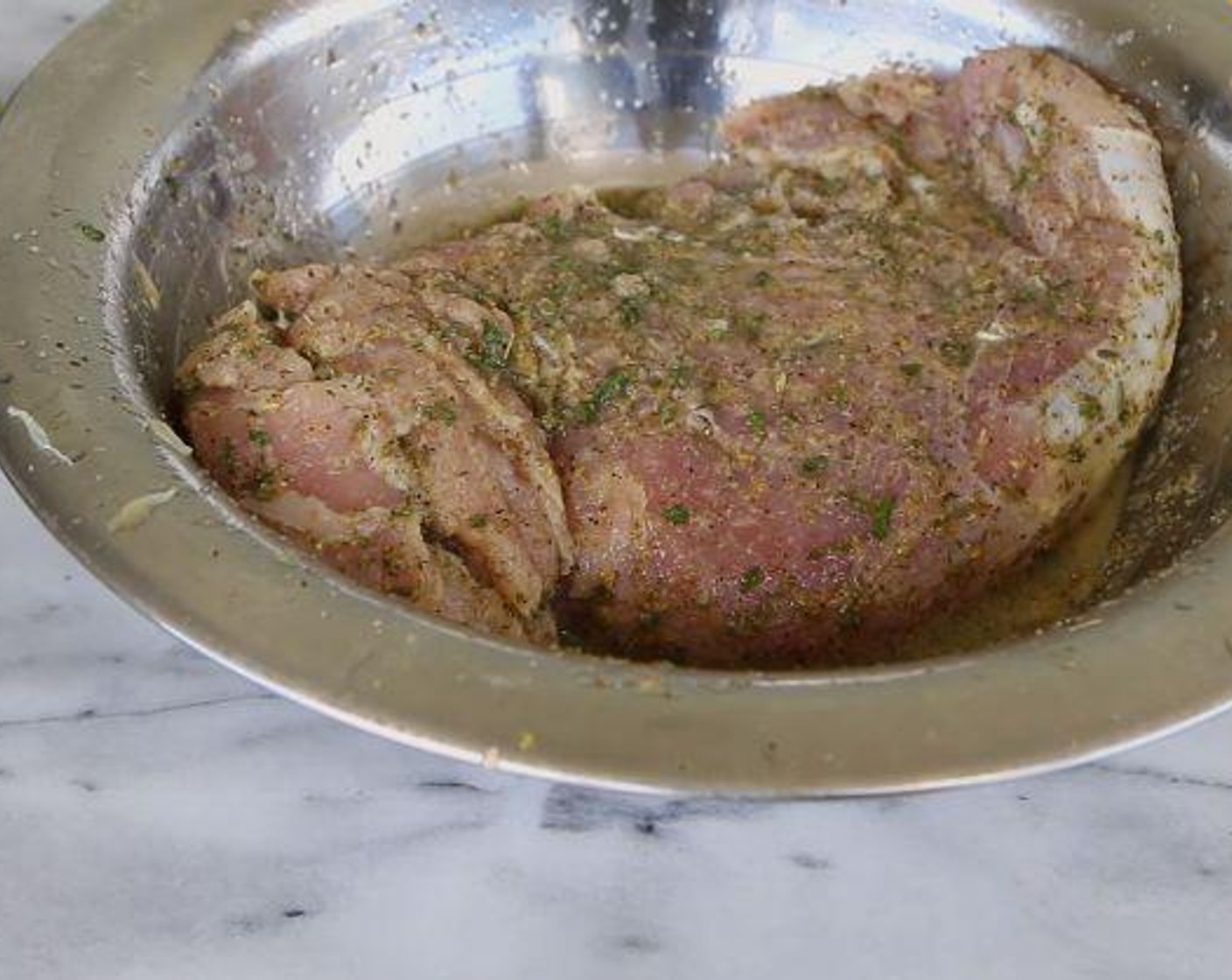 step 1 With a fork, poke some holes into the Pork Tenderloin (1 lb). In a bowl, place the pork and add the McCormick® Garlic Powder (1 tsp), Onion Powder (1 tsp), Dried Oregano (1 tsp), Salt (1/2 Tbsp), Ground Black Pepper (to taste), Dried Parsley (1 tsp), Dried Thyme (1/2 tsp), the juice from the Lime (1) and Sunkist Orange (1). Cover and let marinate in the fridge for at least 30 minutes.