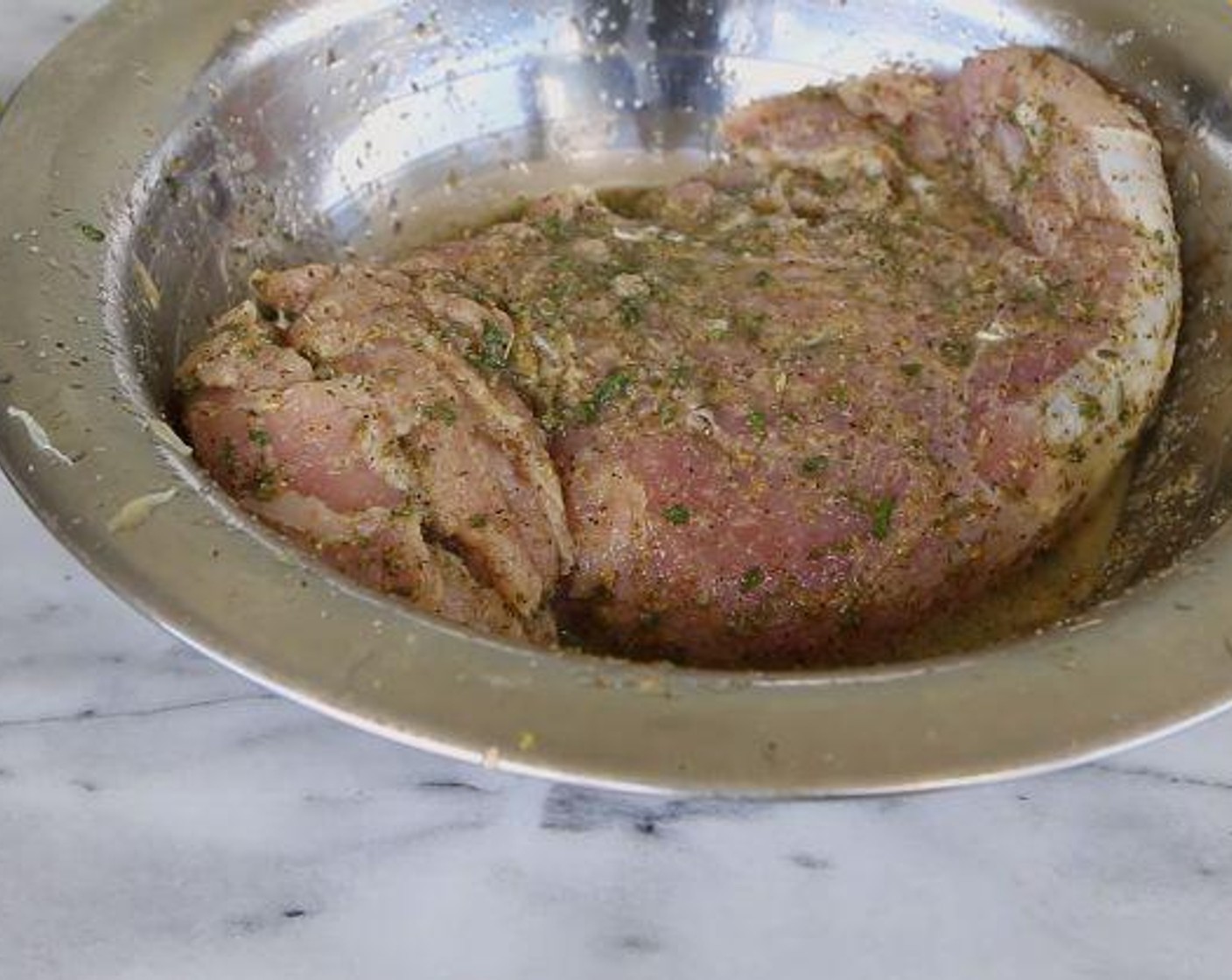 step 1 With a fork, poke some holes into the Pork Tenderloin (1 lb). In a bowl, place the pork and add the Simply Organic Garlic Powder (1 tsp), Simply Organic Onion Powder (1 tsp), Dried Oregano (1 tsp), Salt (1 tsp), Ground Black Pepper (to taste), Dried Parsley (1 tsp), Dried Thyme (1/2 tsp), the juice from the Lime (1) and Sunkist Orange (1). Cover and let marinate in the fridge for at least 30 minutes.