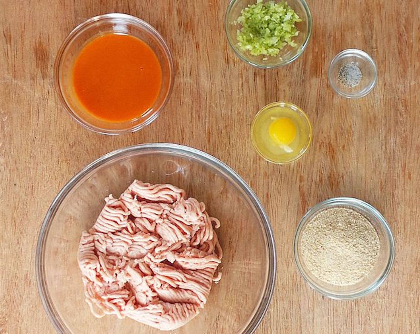 step 5 Add the ground chicken, butter buffalo mixture, celery, Breadcrumbs (1/2 cup), and Egg (1) to a mixing bowl. Season with Salt (to taste) and Ground Black Pepper (to taste). Mix until everything's all combined.