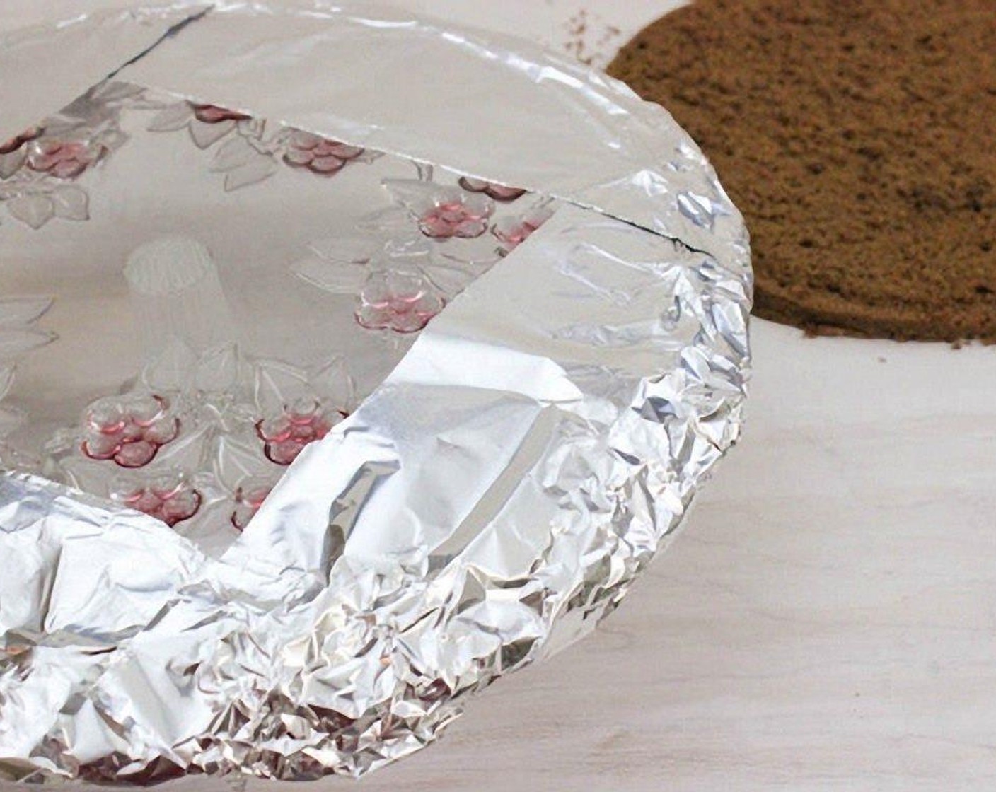 step 25 Assembling the cake: Line the edges of a round cake platter with aluminum foil or parchment paper.
