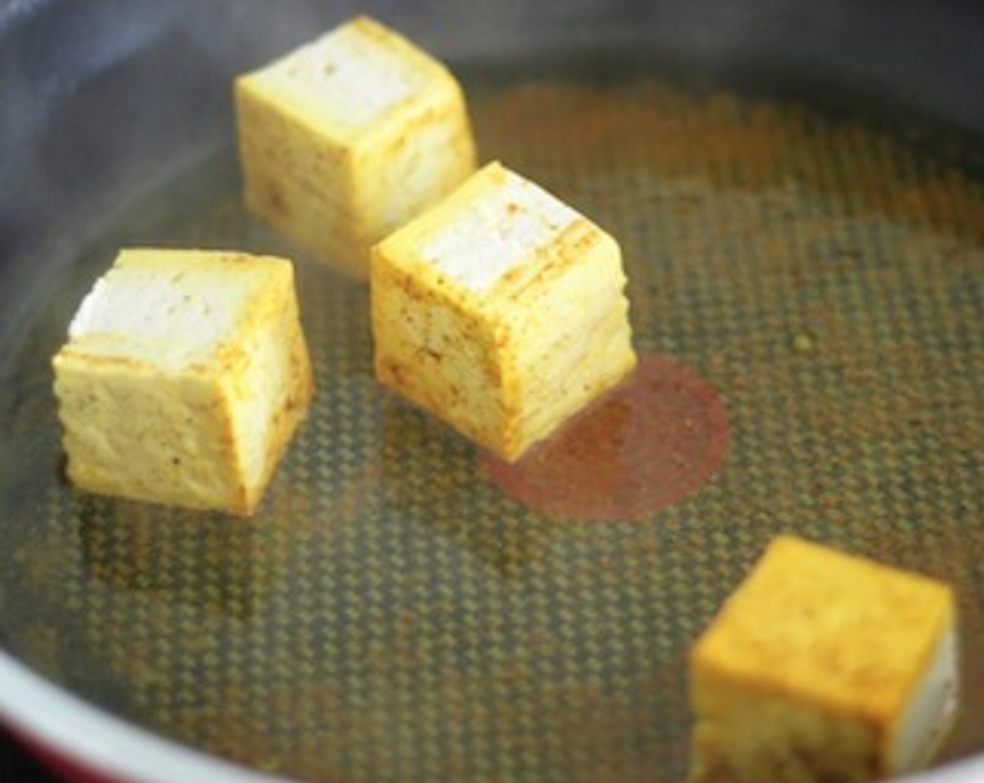 step 7 For magic boxes, cut the tofu into cubes and fry them in the pan, but this time instead add  Curry Powder (2 Tbsp) and a bit of water. Fry them until they turn yellow.