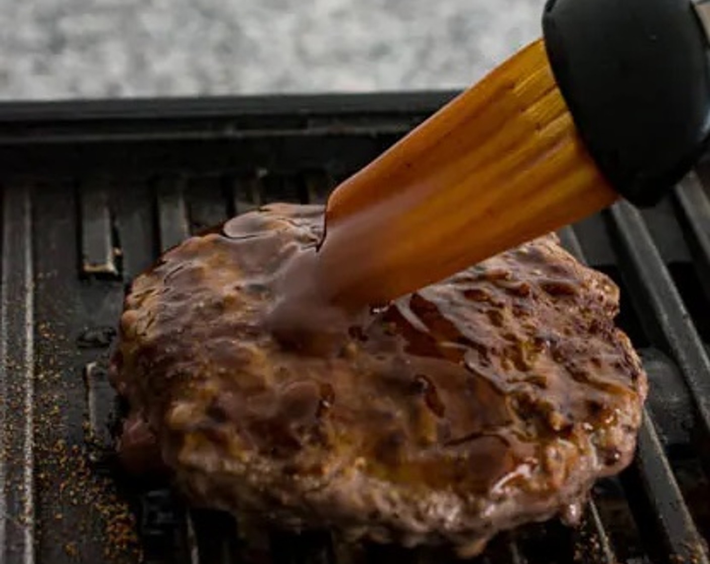 step 4 Sear the other side for another 1 minute (or longer if you prefer your burgers well done). Baste each side of the burger with the teriyaki sauce while it is still on the grill/skillet. When the burger patties are cooked, set them aside.