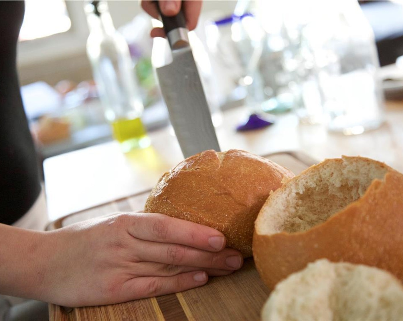 step 13 While the chowder simmers, slice a circle around the top of each loaf of Sourdough Bread Boule (2) and remove the lid. Using your hands, hollow out the inside of each loaf, making a bowl, leaving the walls about a half inch thick.