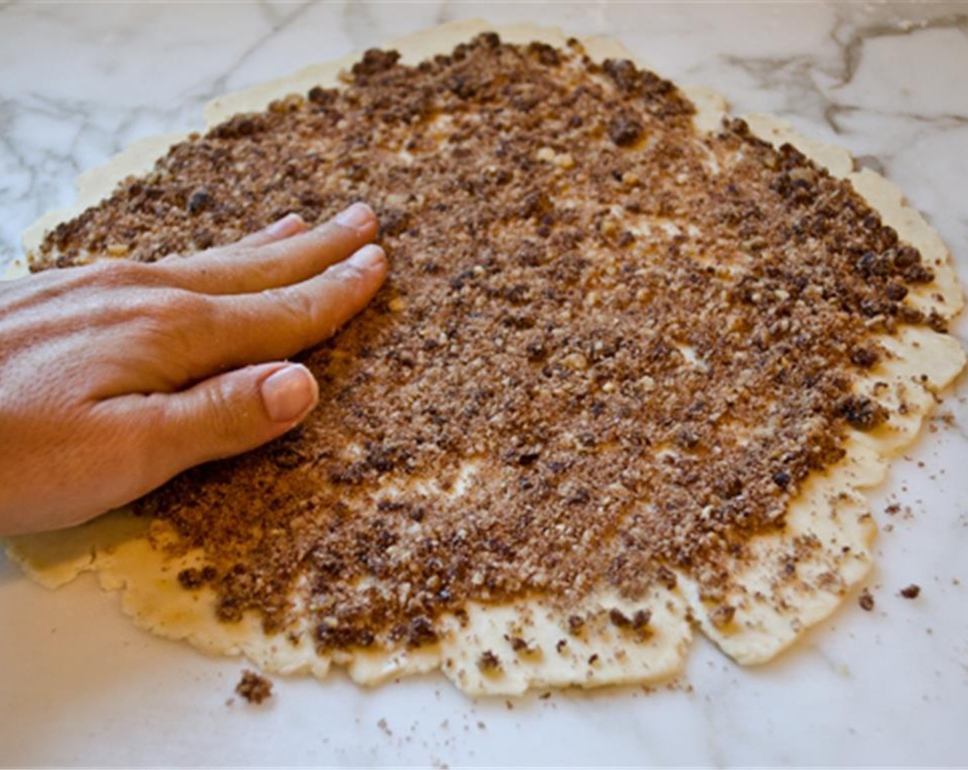 step 8 Spread 1/2 cup of the filling over the dough and lightly press it into the dough with your hands.