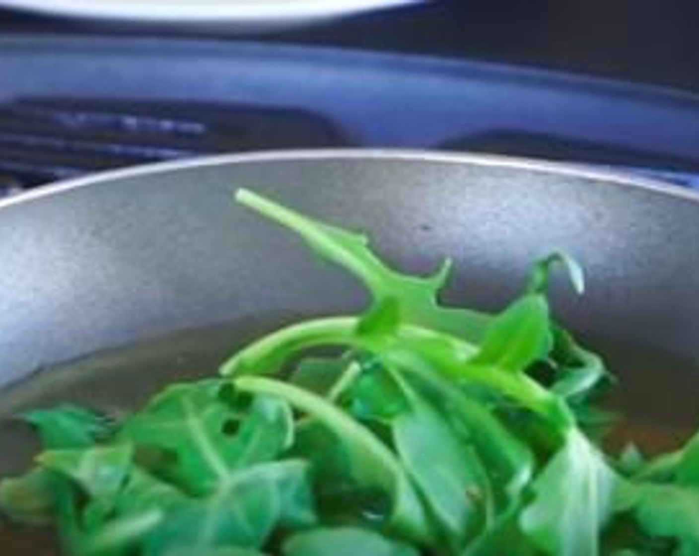 step 7 Fill a small frying pan with Olive Oil (as needed) and add the Arugula (2 1/2 cups). Fry this on the BBQ until you notice the leaves become dark green. Using tongs, remove each leaf from the pan and place them onto paper towels so excess oil is removed.