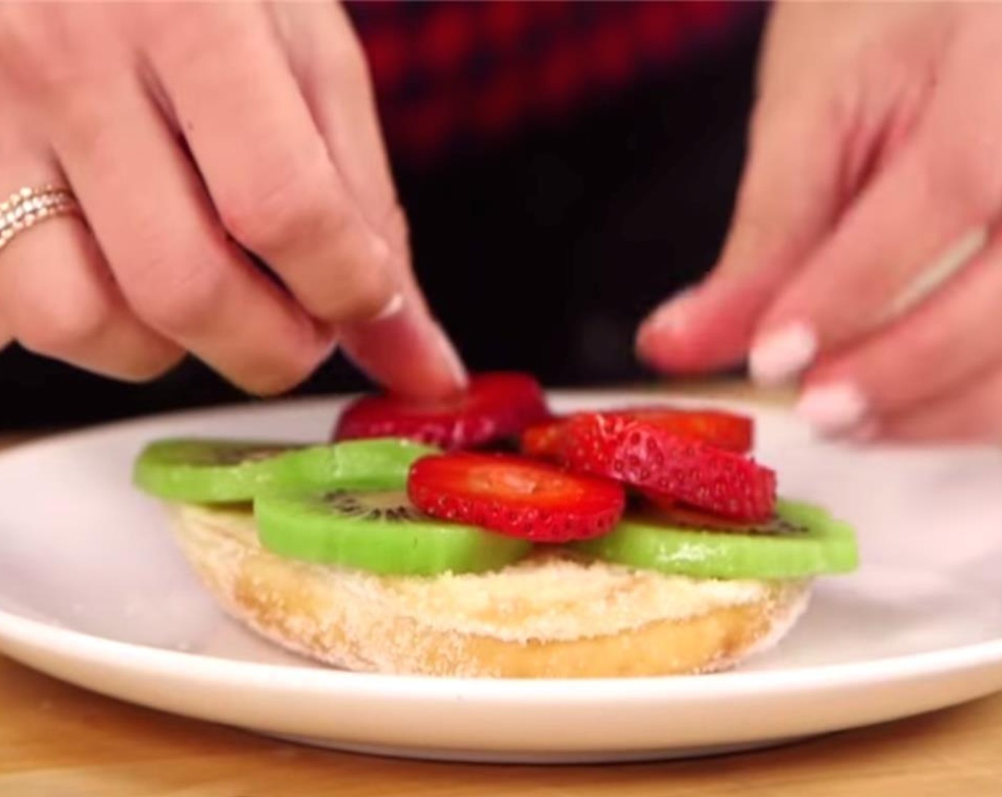step 3 To assemble the burger, start by slicing the Sugar Donuts (2) in half like a hamburger bun. Add the sliced Kiwifruit (1) and thinly sliced Fresh Strawberries (4) to the bottom half of the "buns."