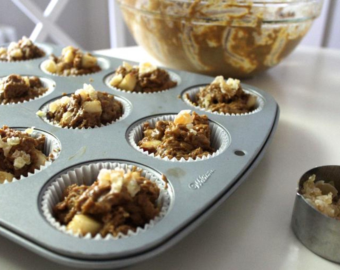 step 6 Scoop the batter into the prepared muffin pan, filling each cup almost to the top. Sprinkle each muffin with a little Crystallized Ginger and bake for about 20 minutes, until a cake tester inserted in the middle comes out clean.