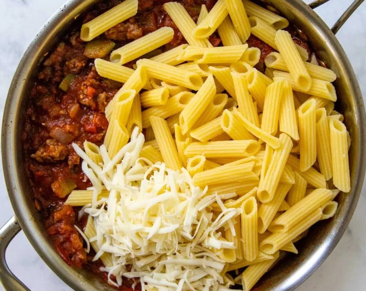 step 6 Stir in the half the cooked pasta and Mozzarella Cheese (1/2 cup). Toss to combine then add the remaining cooked pasta. Toss gently to combine.