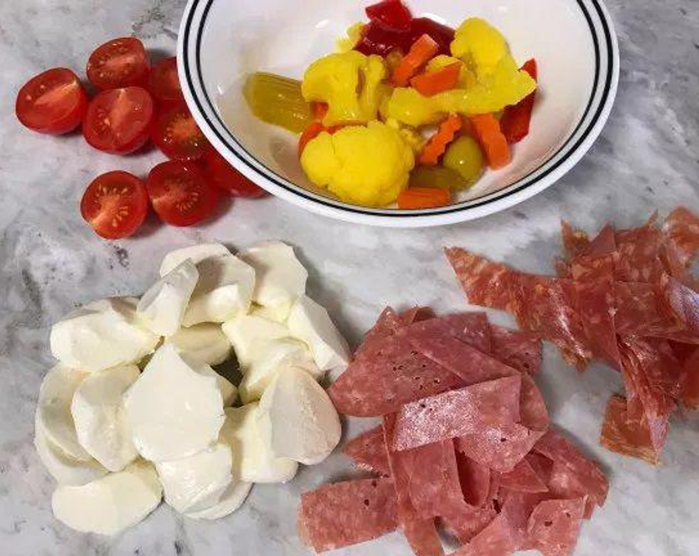 step 1 Start by preparing the toppings. Slice thin slivers of the Salami (4 slices) and Soppressate (4 slices). Slice the Fresh Mozzarella Cheese Ball (2/3 cup). Cut the Cherry Tomatoes (4) into halves. Measure out the pickled Mixed Vegetables (1/2 cup). If preparing ahead of time, refrigerate toppings until ready to cook.