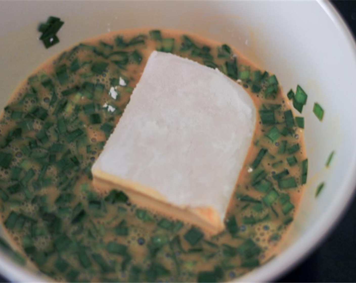 step 3 Dip the tofu into the egg mixture.