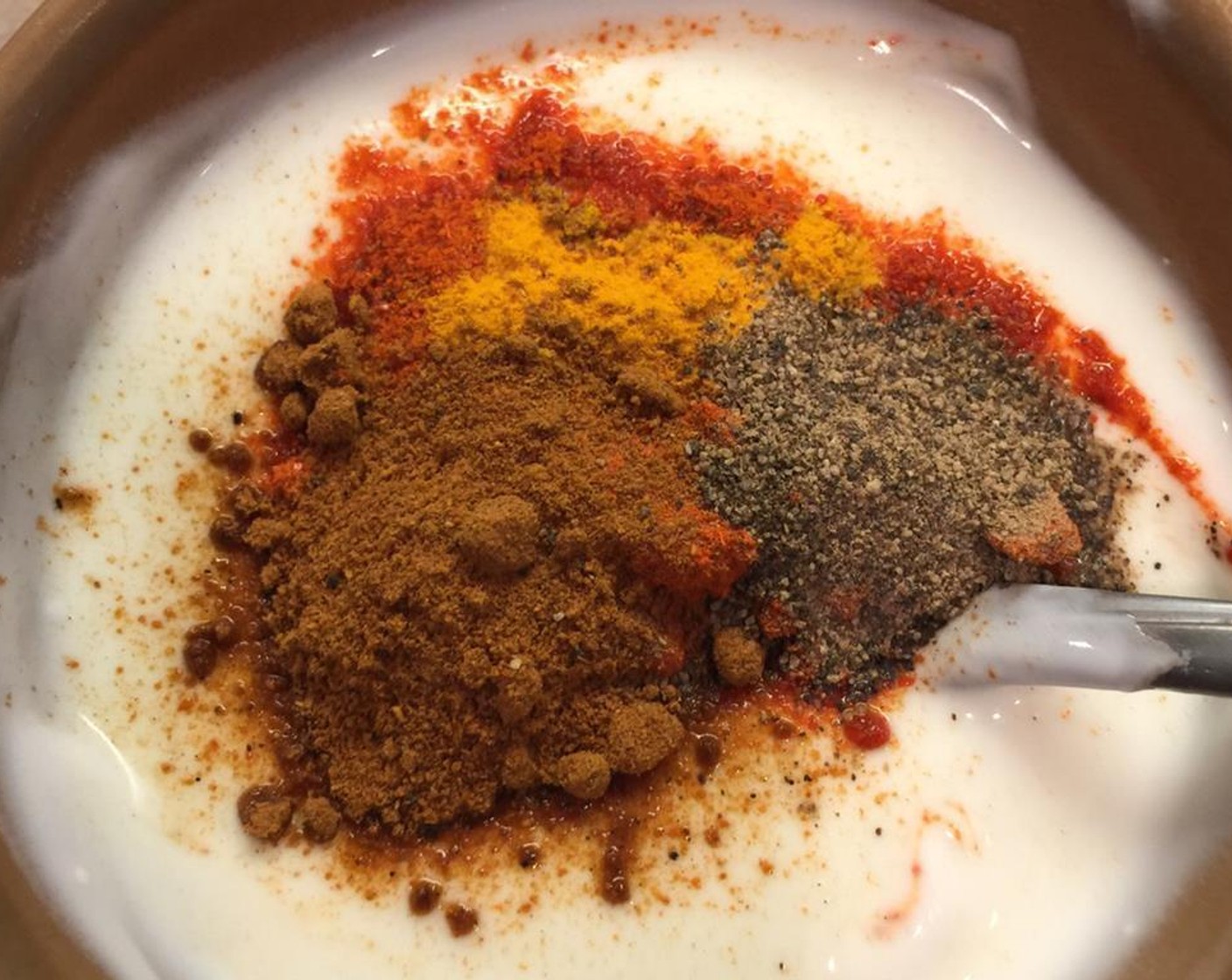 step 1 In a bowl, whip Yogurt (1 cup) properly without forming lumps. Add Ginger Garlic Paste (1 tsp), Red Chili Powder (2 Tbsp), Ground Turmeric (1 pinch), Garam Masala (1 tsp), Salt (1 Tbsp) and Ground Black Pepper (1 Tbsp). Mix well.
