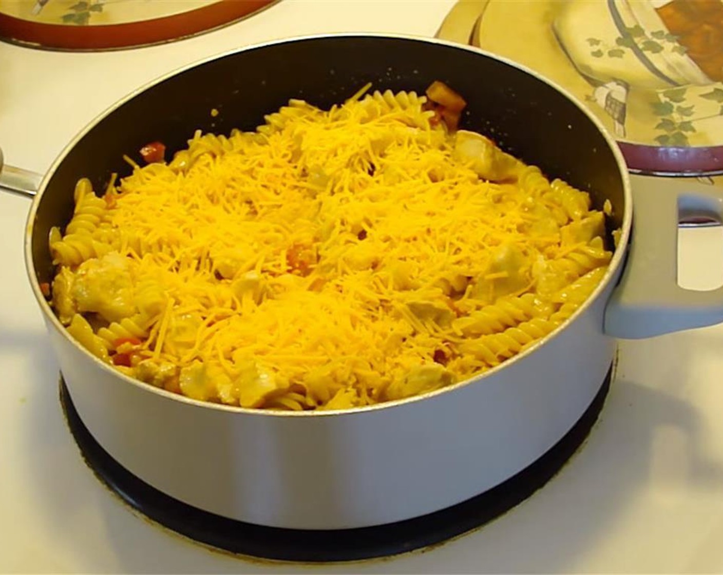 step 4 Toss cooked pasta with chicken mixture, and sprinkle with Shredded Cheddar Cheese (1/2 cup).