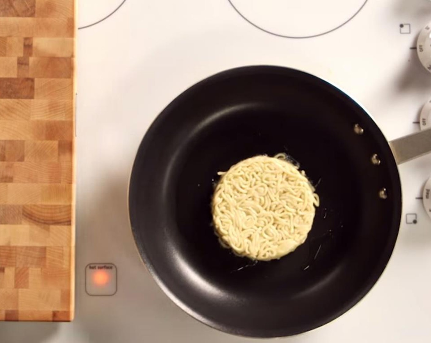 step 4 Add the Canola Oil (2 Tbsp) to a skillet, and set over medium-high heat. Once the oil begins to shimmer, unmold the ramen buns into the pan, and cook until the bottom is a dark golden brown.