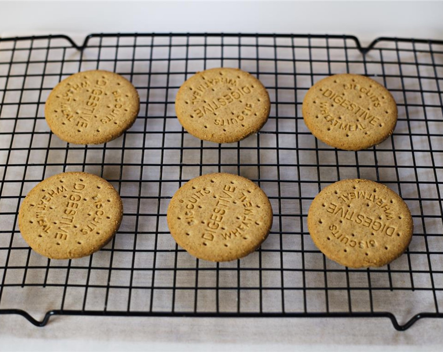 step 1 Put the Digestive Biscuits (12) on a wire rack with a piece of wax paper placed underneath it.