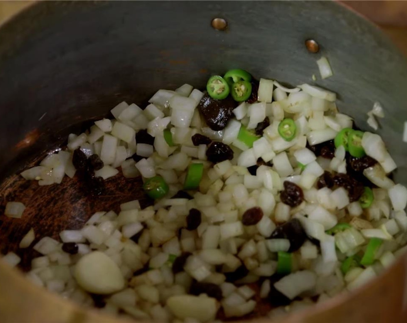 step 2 Chop the Onions (3 cups), Garlic (5 cloves) and Jalapeño Peppers (2). Add these along with Raisins (1/3 cup) to the pot.