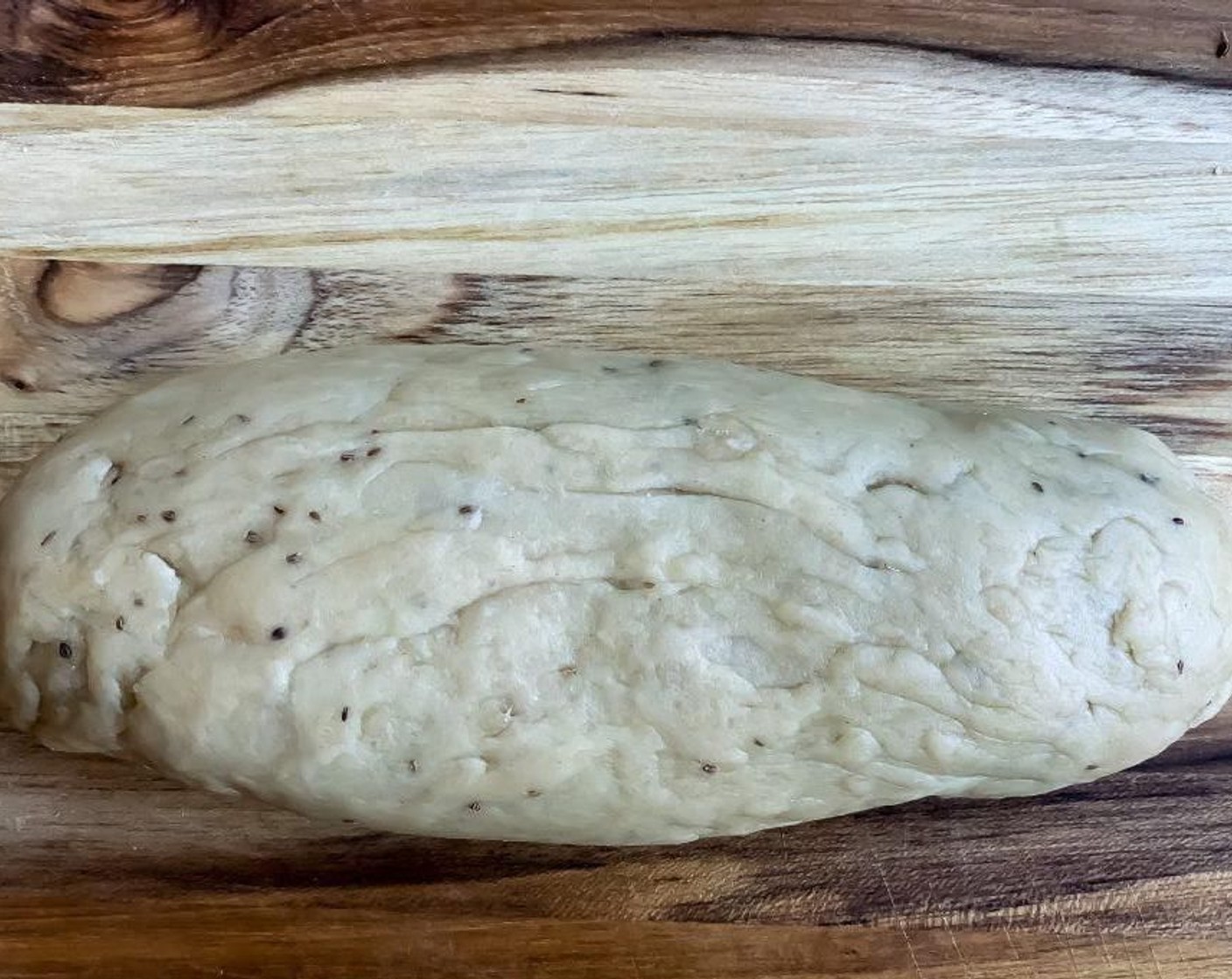 step 12 While the potato filling is getting cool, take out the rested dough on a flat surface. Knead the dough few more times using knuckles and form one long log of dough.