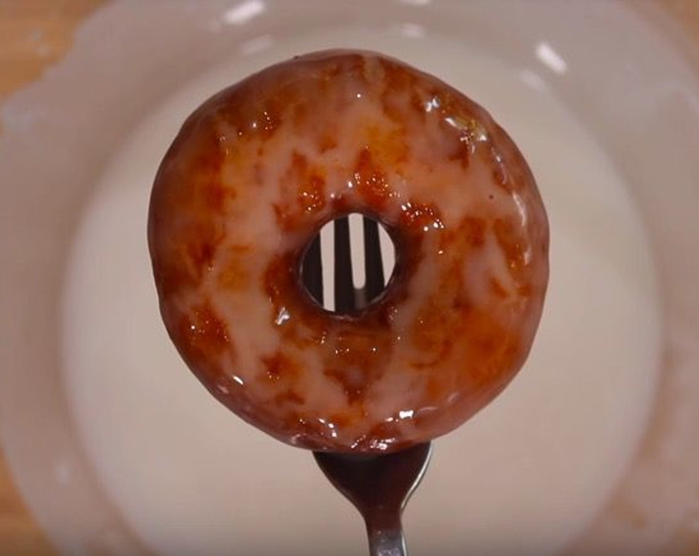 step 10 While the donuts are still warm, dip them into the glaze and coat them on all sides. Leave them on a wire rack to dry.