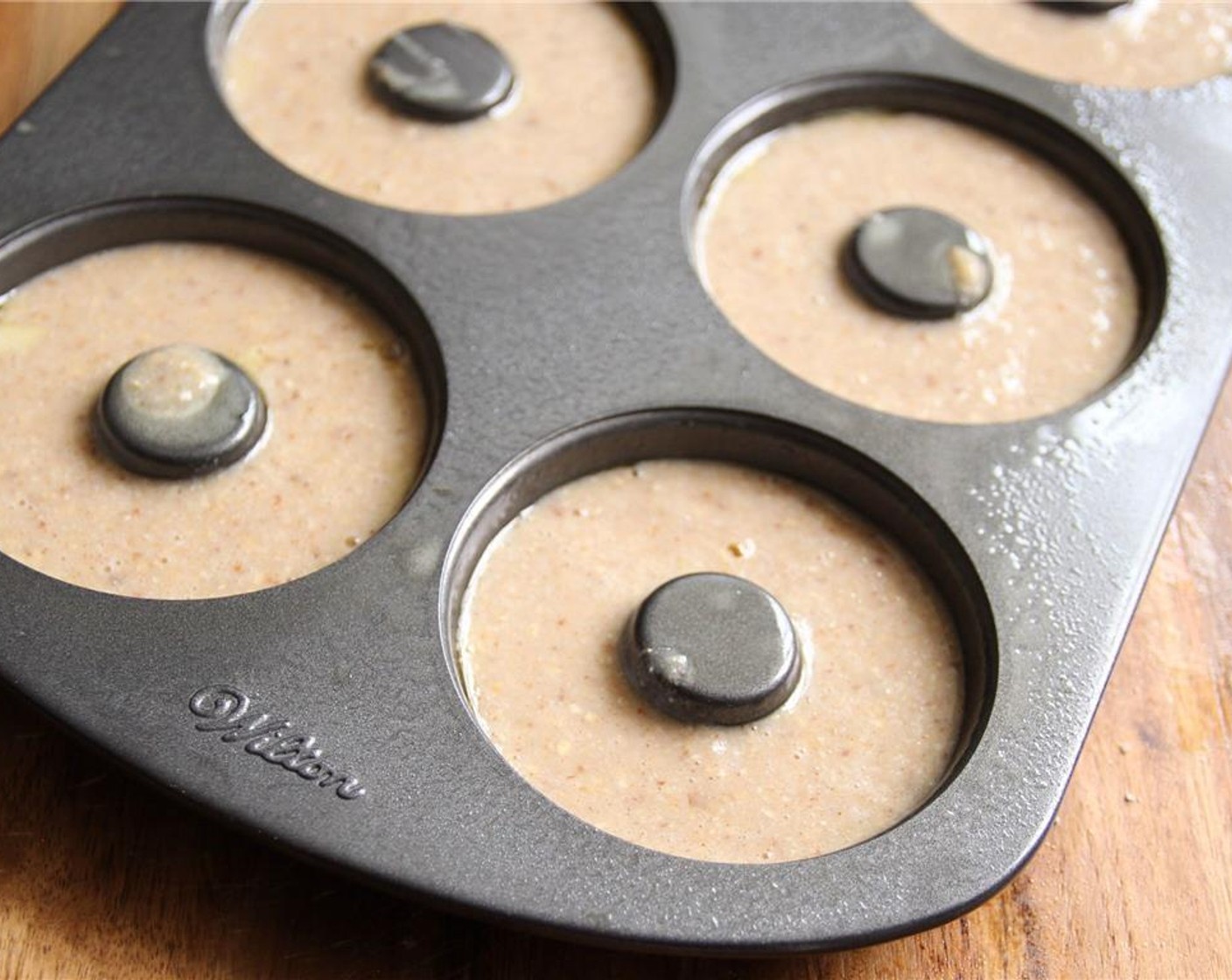 step 5 Spoon the batter into the doughnut molds filling to just below the top of each mold, 1/8" to 1/4" from the top.