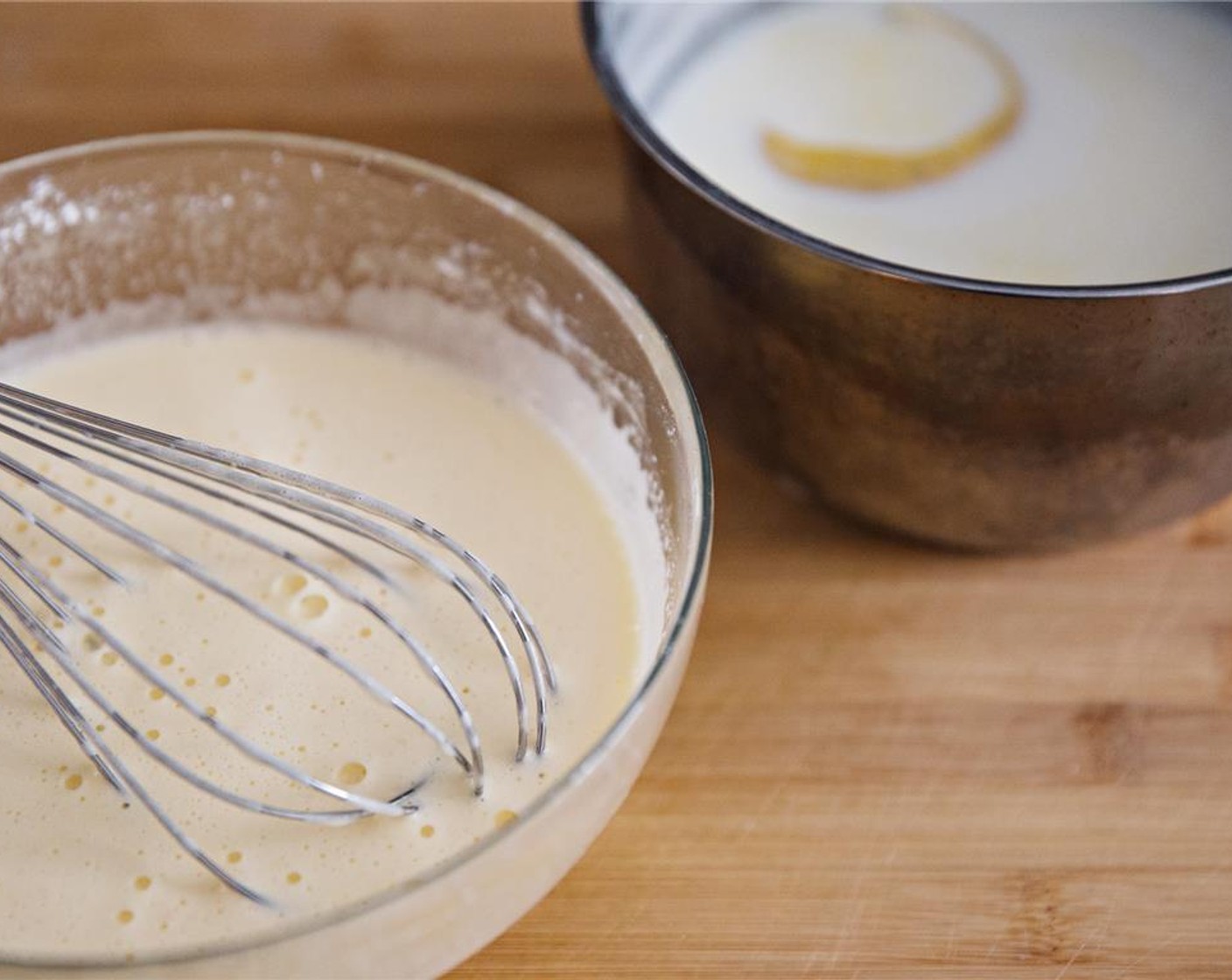 step 4 When the milk mixture has come up to a boil, remove from the heat and add a small amount to the egg and sugar mixture. Whisk well and continue adding milk to the egg mixture, until everything is combined into a thin custard.