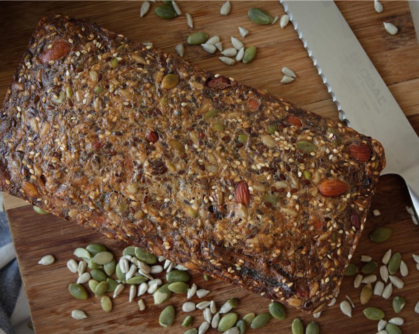 step 2 Grease and line a loaf tin with baking paper, leave the long sides overhanging. Mix Raw Almonds (3/4 cup), Eggs (3), Coconut Oil (1/2 cup), Flaxseeds (1/2 cup), Sunflower Seeds (1/2 cup), Pepitas (1/2 cup), Sesame Seeds (1/4 cup), and Medjool Dates (5) in a bowl.