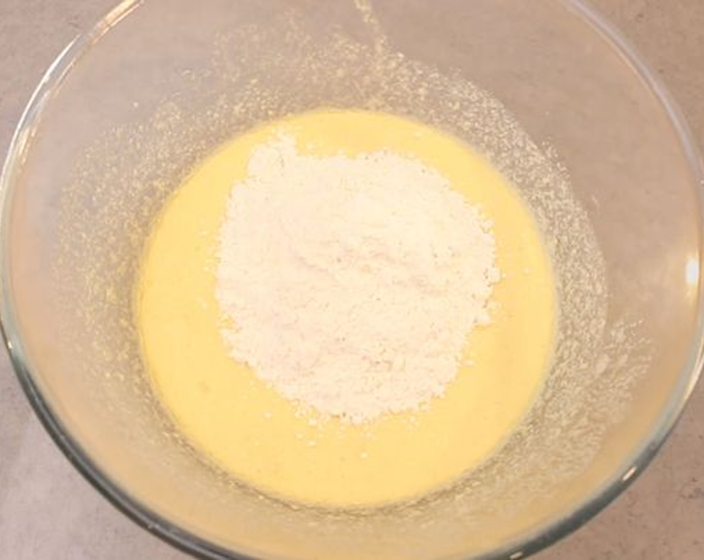 step 2 Into a large bowl add the Caster Sugar (1/2 cup) and Eggland's Best Classic Eggs (3) and then whisk until pale and creamy. Then add the Butter (2 oz) and whisk that in, now add the Vanilla Extract (1 tsp) and Self-Rising Flour (1/3 cup). Incorporate the flour well until you have a smooth cake batter consistency and then pour the batter into a greased pie dish.