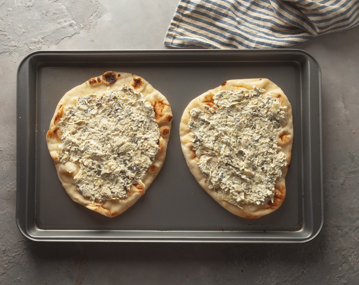step 3 Spread the Spinach Artichoke Dip (2 cups) liberally on each flatbread, leaving a ½-inch border around the edges.