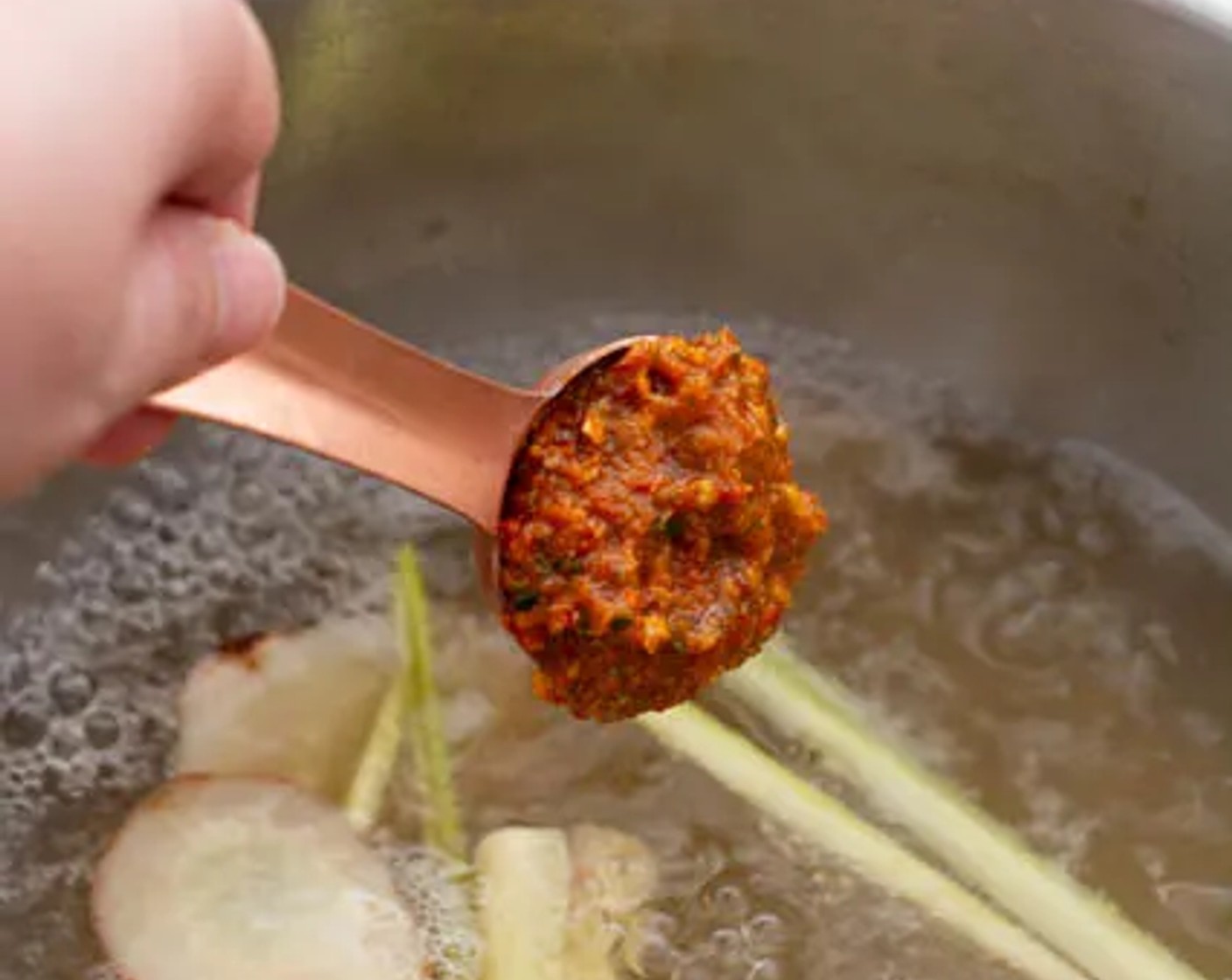 step 2 When the stock starts to boil rapidly, add 1 Tbsp of the Tom Yum Chili Paste (2 Tbsp), then do a taste test before adding the remaining tablespoon (if needed).